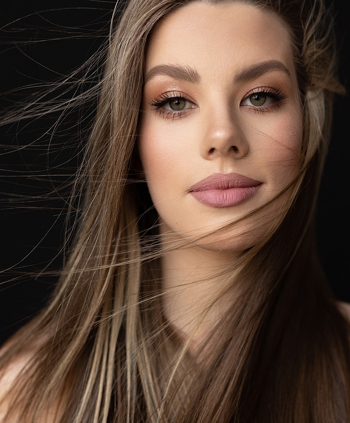 Portrait of a woman with flowing hair.