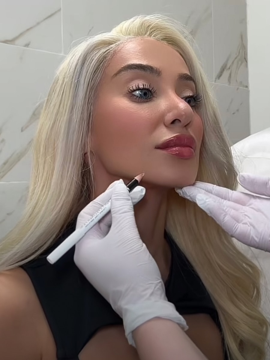 Woman getting makeup applied before photography session.