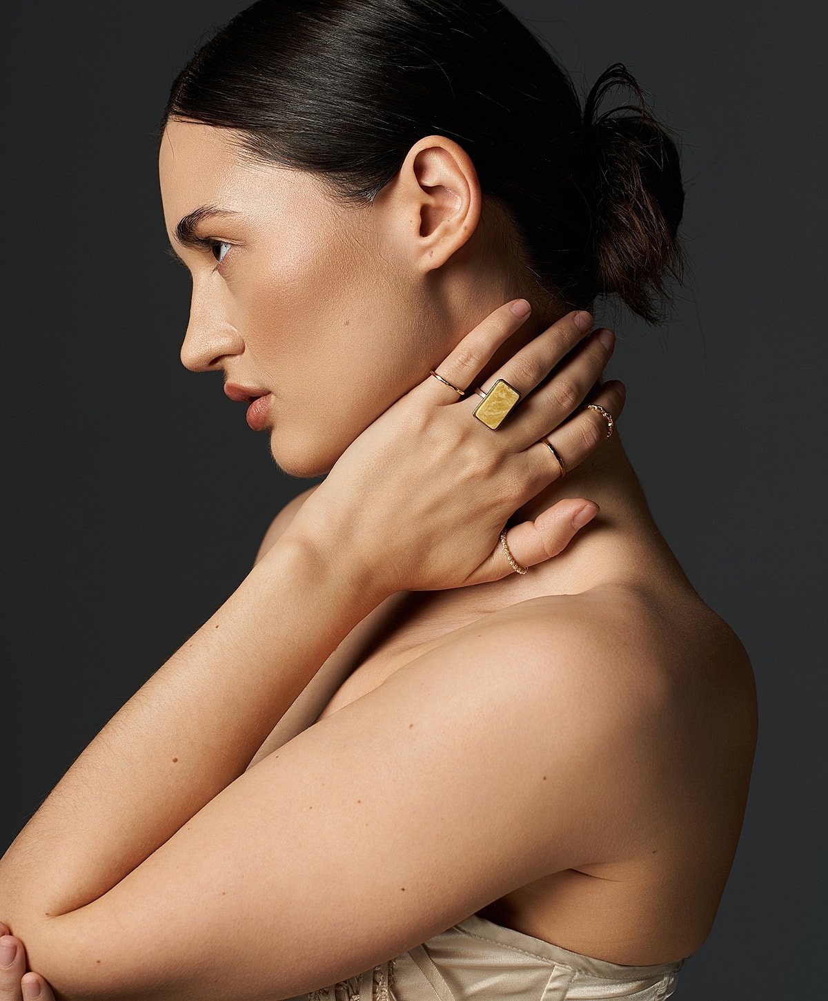 Model showcasing elegant jewelry and profile.