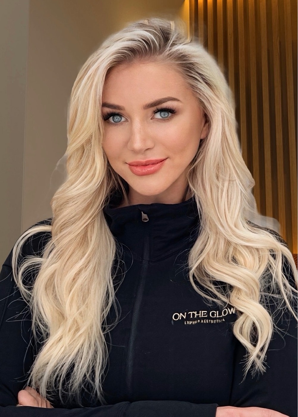 Blonde woman smiling in professional attire.