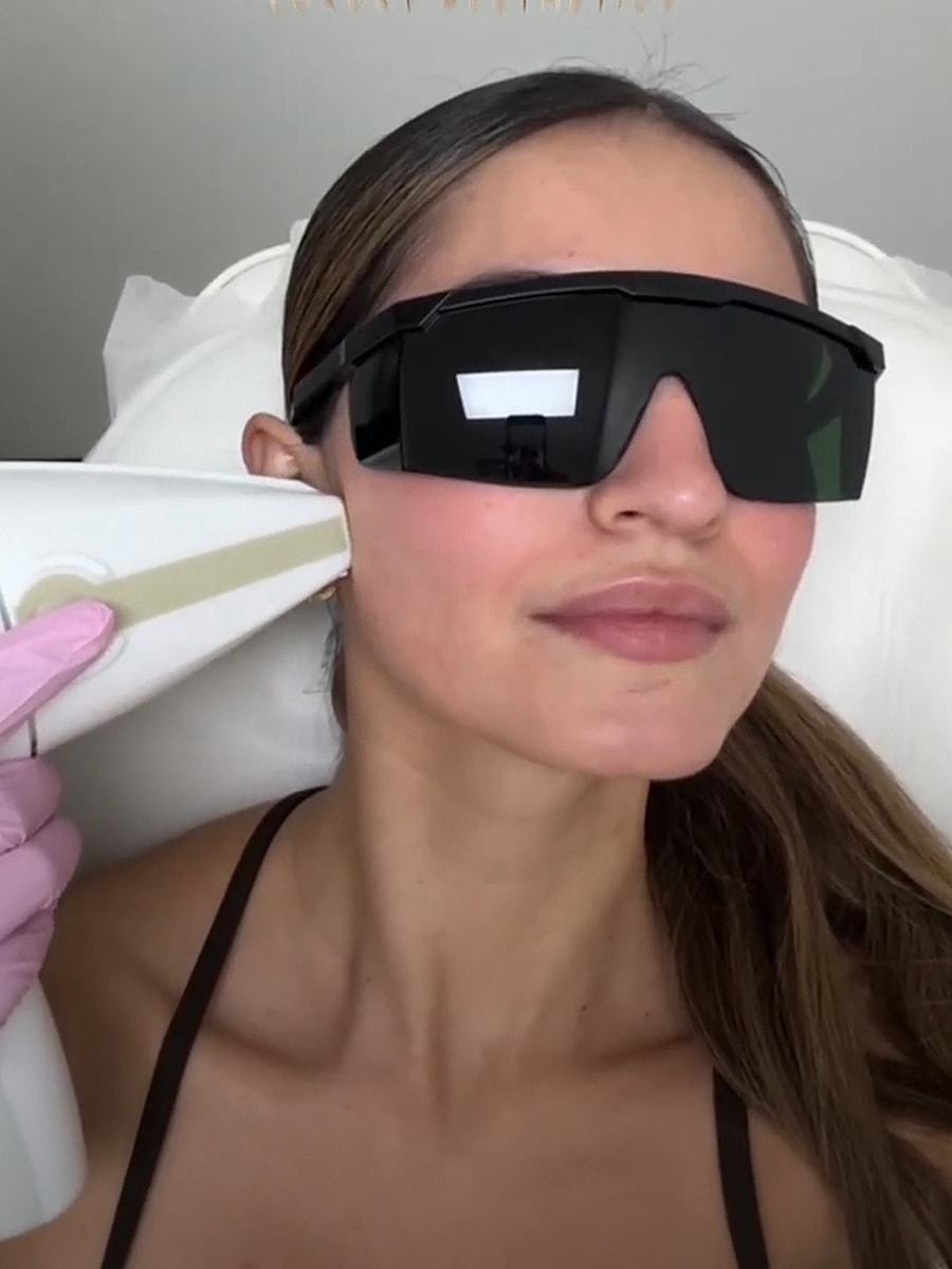 Woman undergoing a beauty treatment with laser device.