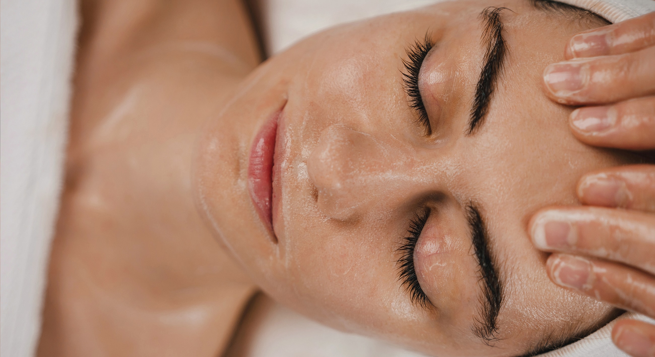 Woman enjoying a facial massage treatment.