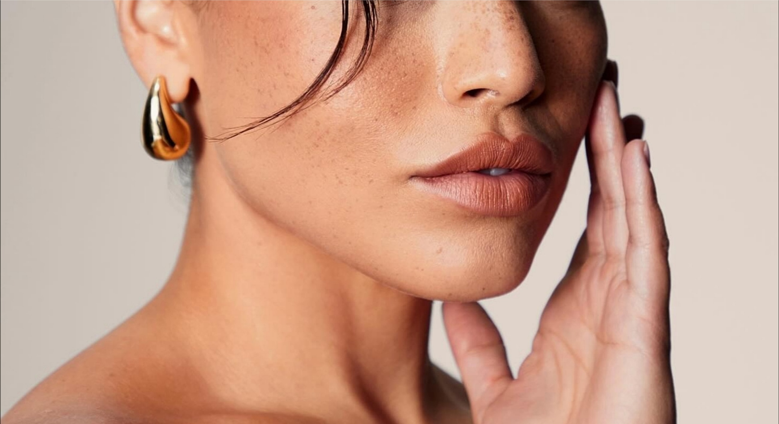 Close-up of a woman's face and jewelry.
