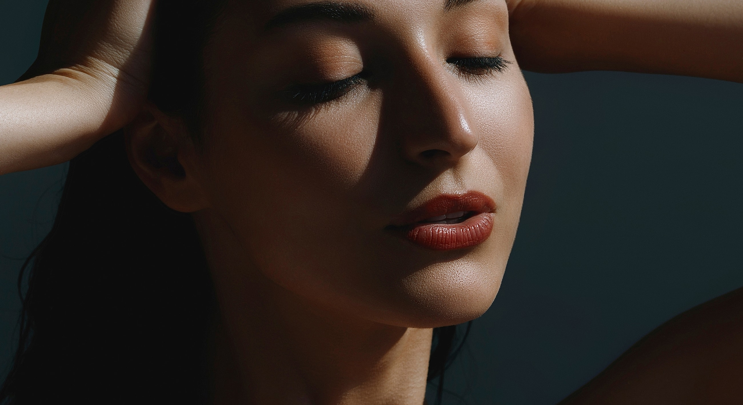 Close-up of a woman's serene face.
