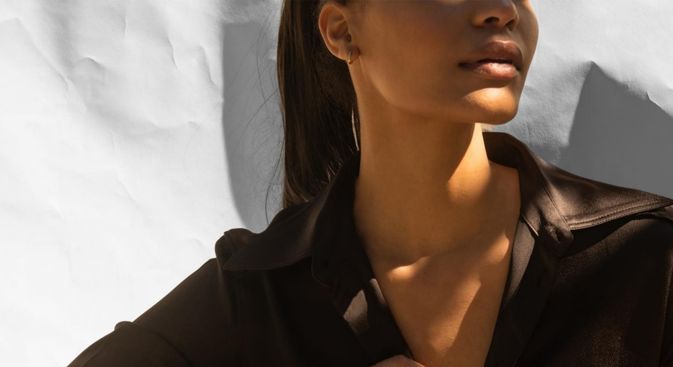 Woman in a black shirt with soft lighting.