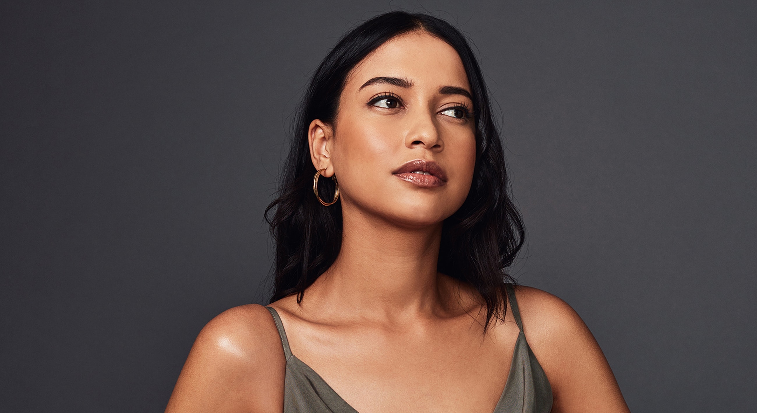Woman with long hair and hoop earrings.